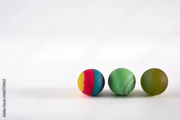 Fototapeta Rubber ball of various colors on a keyboard.