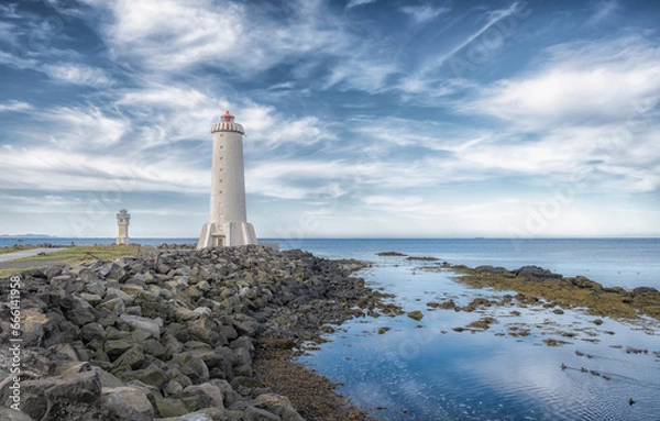 Obraz Akranes lighthouses on the west coast of Iceland. Bigger lighthouse is operational and smaller is deactivated old one. White building by the sea