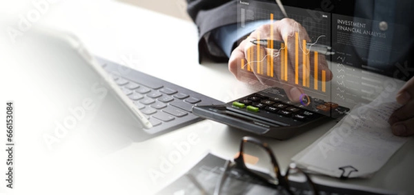 Fototapeta businessman using calcurator and digital tablet with business financial analysis  investment concept, invest money, business and finance, capital fundraising, dollar loan credit .