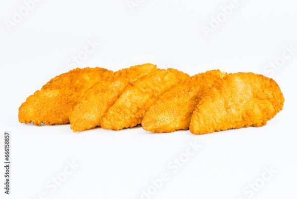 Obraz Fast food. Breaded Chicken Inner Fillet on a White Background,Chicken Breaded Raw Meat. Fast cooking. Breaded chicken nuggets. Homemade food at home. Chicken Breaded Fillet.