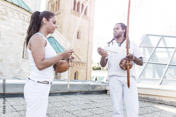Fototapeta Capoeira, berimbau musical instrument in their hands