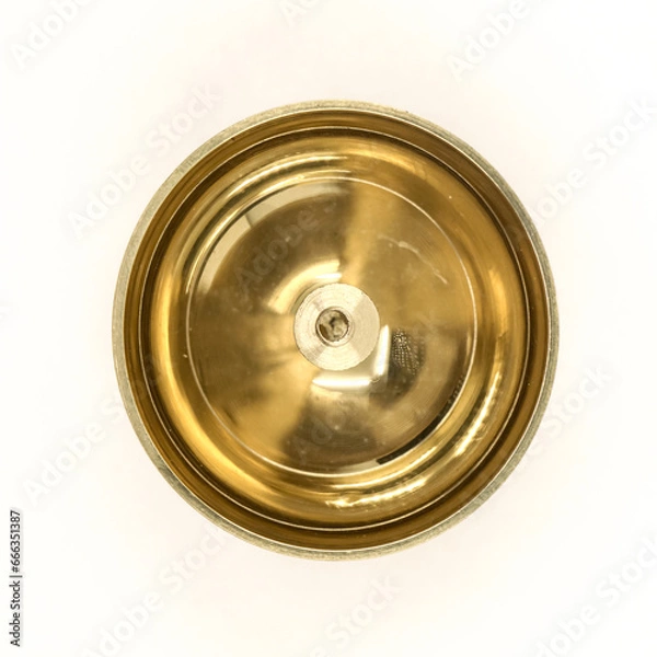 Fototapeta a shiny round brass oil lamp with wick holder isolated in a white background viewed from the top