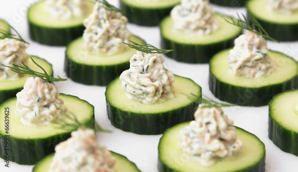 Fototapeta Salmon mousse served on cucumber slices, garnished with dill