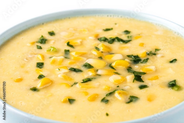 Fototapeta Corn soup in green bowl isolated on white background. Close up