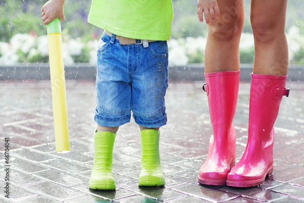 Obraz Child and mother wearing pink and green rain boots