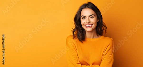 Obraz autumn banner with cute smiling model woman against orange background. thanksgiving banner with copy space