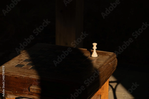 Fototapeta Queen chess piece on an outdoor board by itself