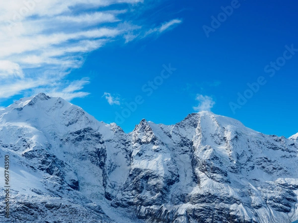 Obraz Close view of Piz Morteratsch on the right, Piz Prievlus in the middle and Piz Bernina on the left, against blue sky background.