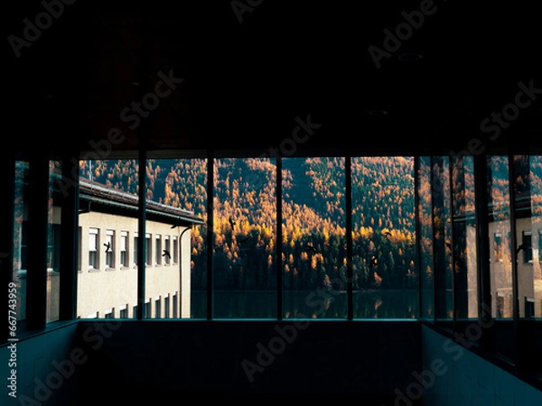 Obraz Magnificent autumn atmosphere of St.Moritz through glass window. Famous and luxury ski resort town, located in the upper Engadin valley in the south-eastern corner of Switzerland.