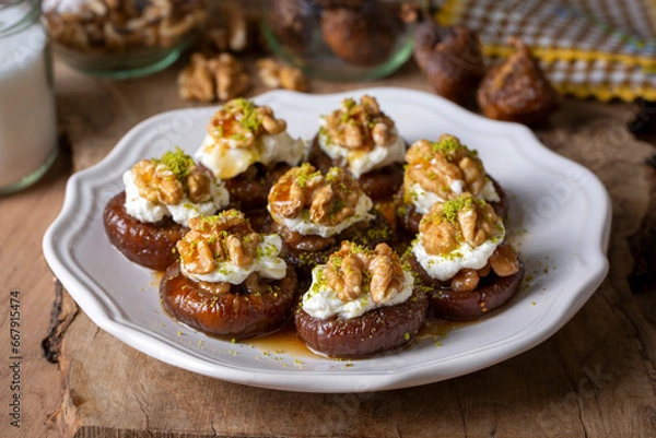 Obraz Stuffed dry fig dessert, cooked with syrup, traditional, pistachio and kaymak (Turkish name; kaymakli incir tatlisi )