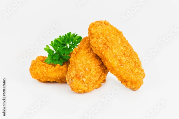 Obraz Semi-finished product, fried wings.Breaded Chicken wings with salad on a White Background,food at home.Fast homemade food.Chicken Breaded Raw Meat. Fast cooking.