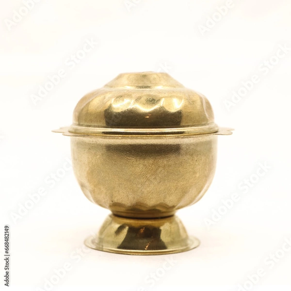 Obraz a golden container pot with vintage design and a lid for the box used to store food spice or sindoor powder isolated in a white background