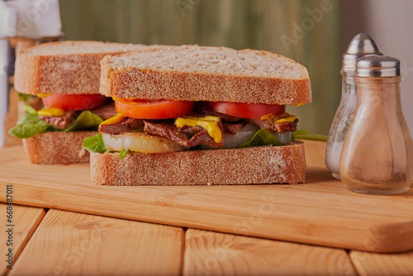 Obraz Beef steak sandwich made with sour dough bread.