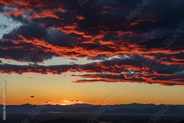 Fototapeta Sunset, clouds on the horizon illuminated by the red light of the sun
