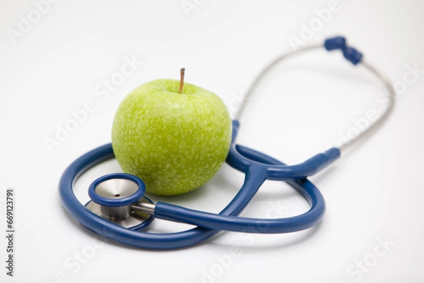 Obraz Apple on white background,stethoscope and apple.