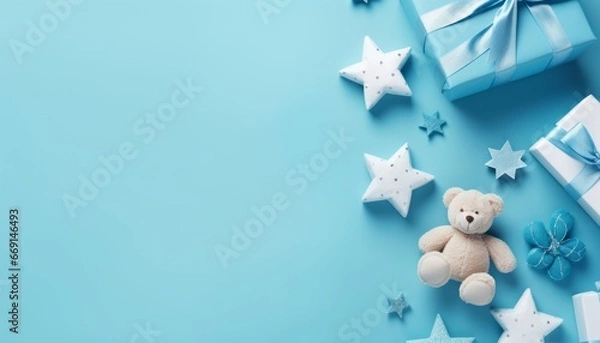 Fototapeta Baby accessories concept top view photo of gift box teether knitted bunny rattle toy and stars on isolated pastel blue background with empty space