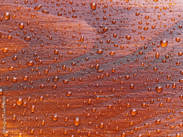 Fototapeta full frame natural background with rain drops on red wooden table