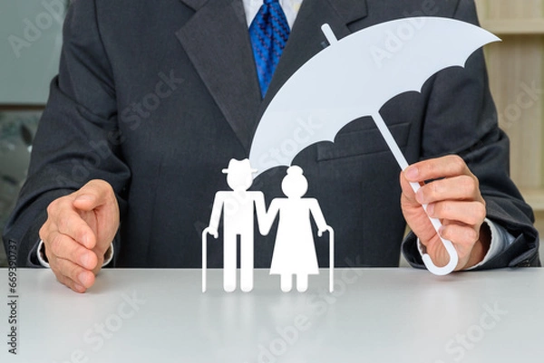 Fototapeta Pension insurance for retirees and social security tax, financial concept : Retired senior couple standing together, find security under the protective coverage of their trusted insurance provider.