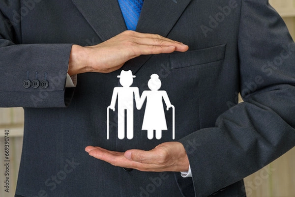 Fototapeta Pension insurance for retirees and social security tax, financial concept : Retired senior couple standing together, find security under the protective coverage of their trusted insurance provider.