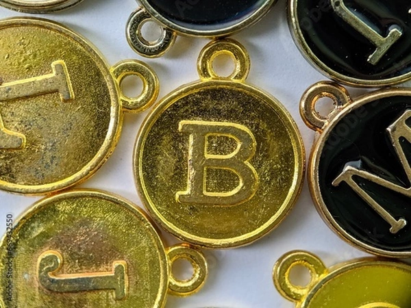 Fototapeta ld initial 'B' pendant in the middle of several letters