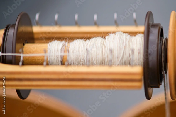 Fototapeta The retro design of the spinning wheel adds a vintage touch to the craft room