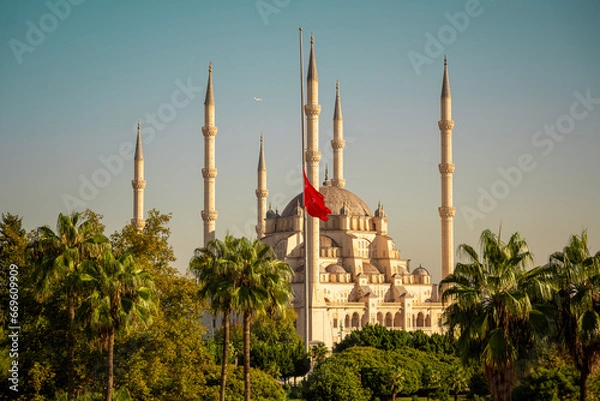 Fototapeta Turkish mosque in Adana city and Turkish flag. Symbol of Islamic culture and faith. Beautiful sacral building in Turkey.