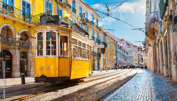 Fototapeta Yellow vintage tram on the street in Lisbon, Portugal. Famous travel destination