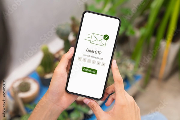 Fototapeta Hand using smartphone and mobile OTP secure verification on send to email with enter password for login banking account on on desk.