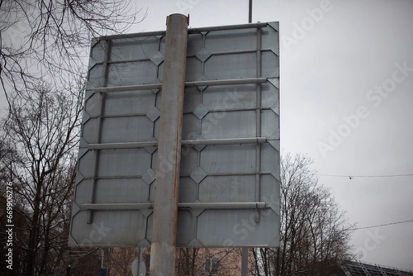 Obraz Road sign at the back. A pole with a sign on the reverse side. The design of the road sign.