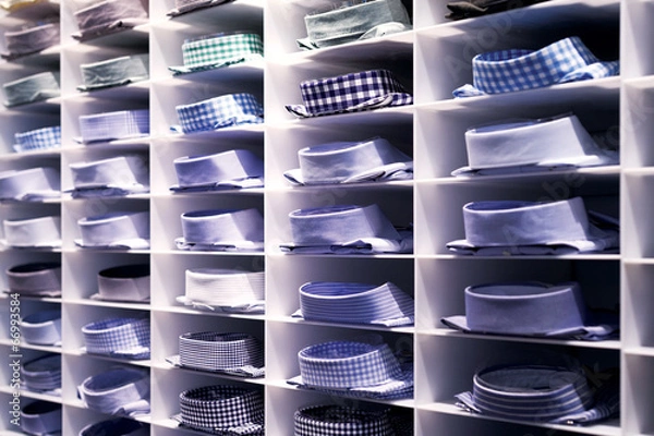 Obraz Folded colourful shirts on clothes rack