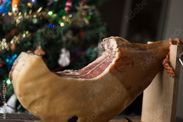 Obraz Whole Serrano ham on a Christmas tree background