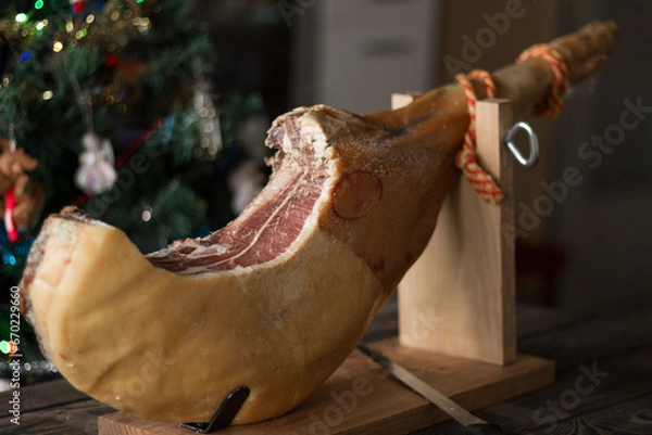 Obraz Whole Serrano ham on a Christmas tree background