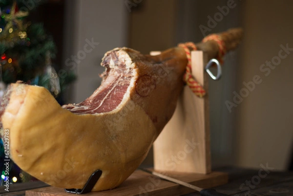 Obraz Whole Serrano ham on a wooden table