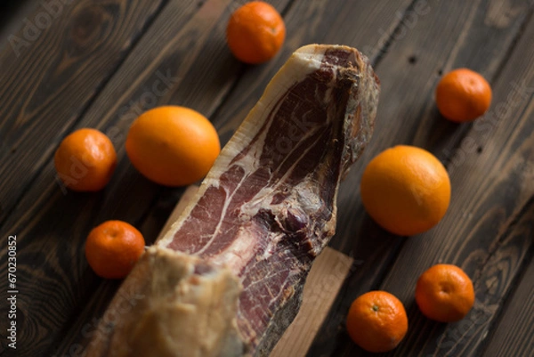 Obraz Top view of whole Serrano ham and oranges