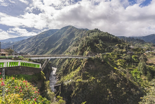 Fototapeta Magnificent view of the river in a deep canyon in the city of Banos, Ecuador. Big bridge across the river.