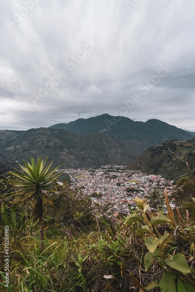 Fototapeta Beautiful view of the city surrounded by big mountains in Ecuador, Banos. 