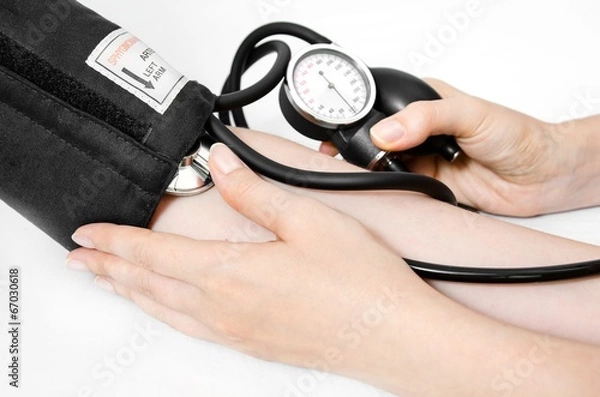Obraz Doctor uses a sphygmomanometer