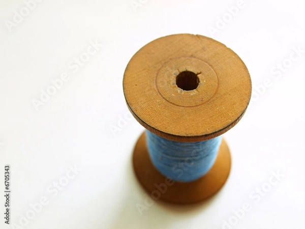 Obraz Blue thread on wooden bobbin