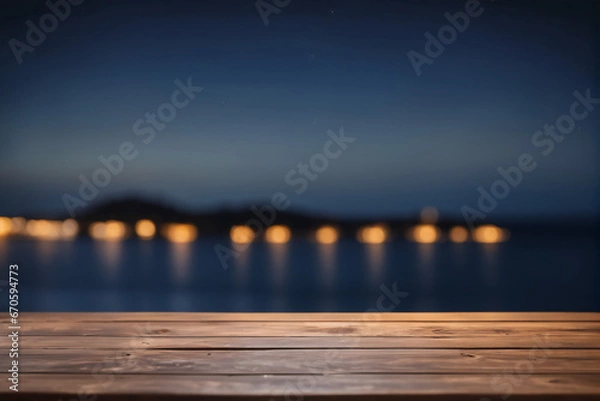 Fototapeta Empty Wooden Table with Blurred Ocean and Island Background at Night