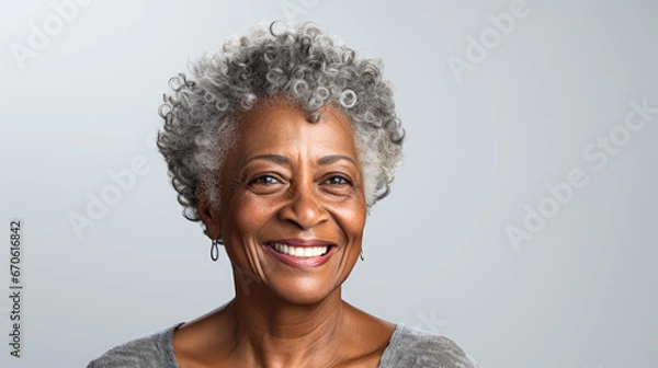 Obraz This close-up studio photo features a senior African American woman with grey hair, isolated on a white background, highlighting her elegance and character.