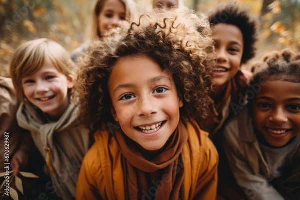 Fototapeta Cheerful multiethnic children group walking in autumn park. Happy smiling boys and girls of different skin colors play and have fun together. Diversity and free communication concept.