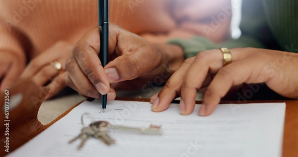 Fototapeta Closeup, hands and signature on mortgage paperwork for finance, home contract or a loan. Investment, legal and a couple writing on a document for keys of a house, ownership and agreement for a deal