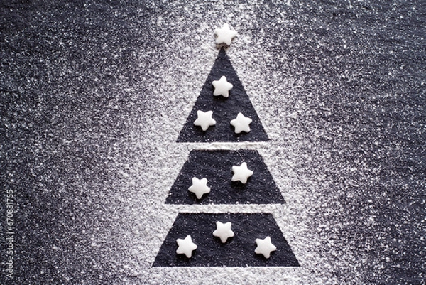 Obraz Christmas tree made of flour on black background, sugar stars, creative christmas background