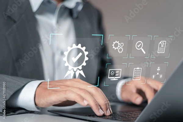 Fototapeta Quality management and Quality control certification, Businessman using computer laptop with quality assurance icon for compliance to regulations and standards.
