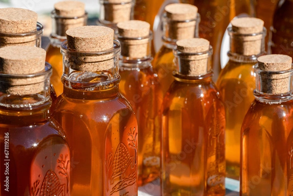 Fototapeta honey bottles with corks at a local farmers market