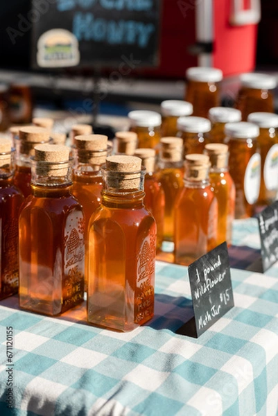 Fototapeta honey bottles with corks at a local farmers market