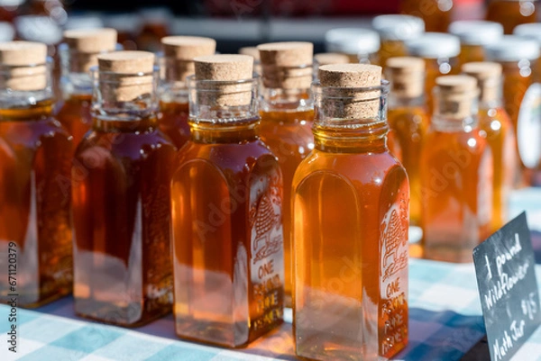 Fototapeta honey bottles with corks at a local farmers market
