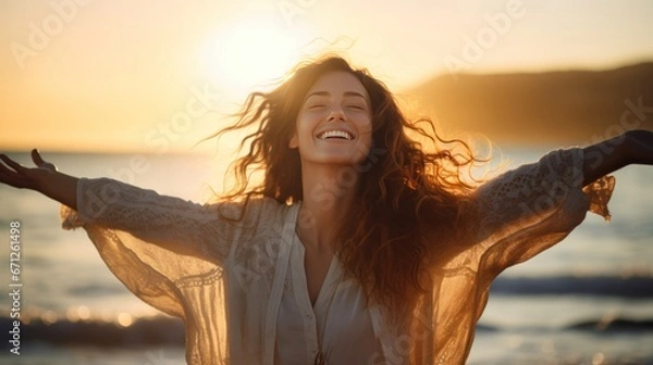 Obraz  Backlit Portrait of calm happy smiling free woman with open arms and closed eyes enjoys a beautiful moment life on the seashore at sunset generative ai