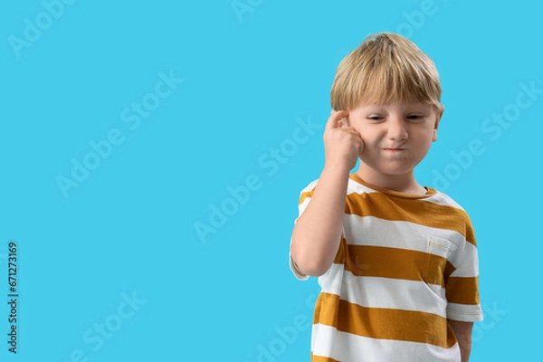 Fototapeta Thoughtful little boy on blue background