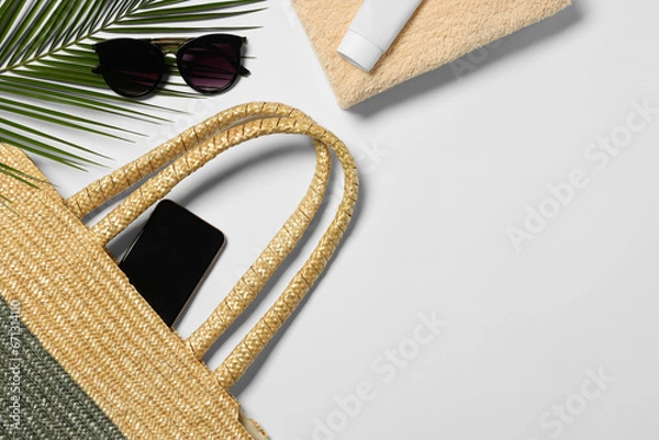 Obraz Flat lay composition with wicker bag, palm leaf and other beach accessories on white background. Space for text